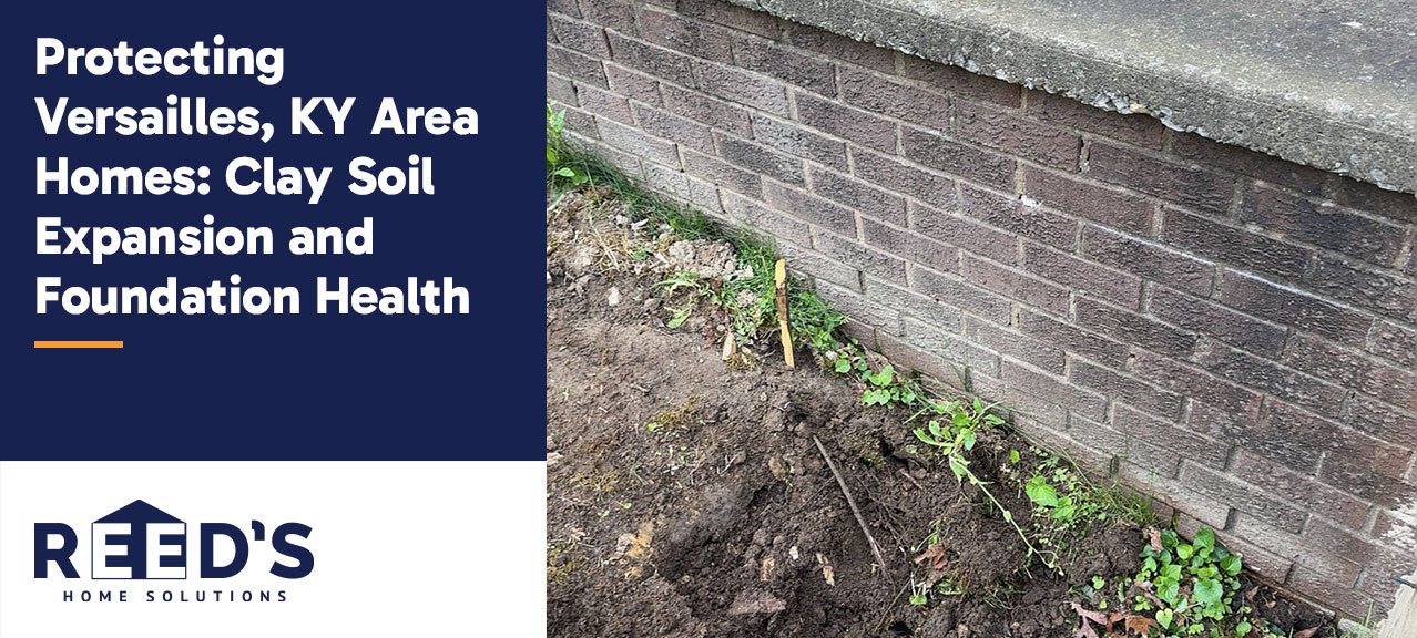 Brick foundation wall of a home in Versailles, Kentucky, with exposed soil along the foundation, illustrating conditions that can contribute to clay soil expansion and potential foundation movement.