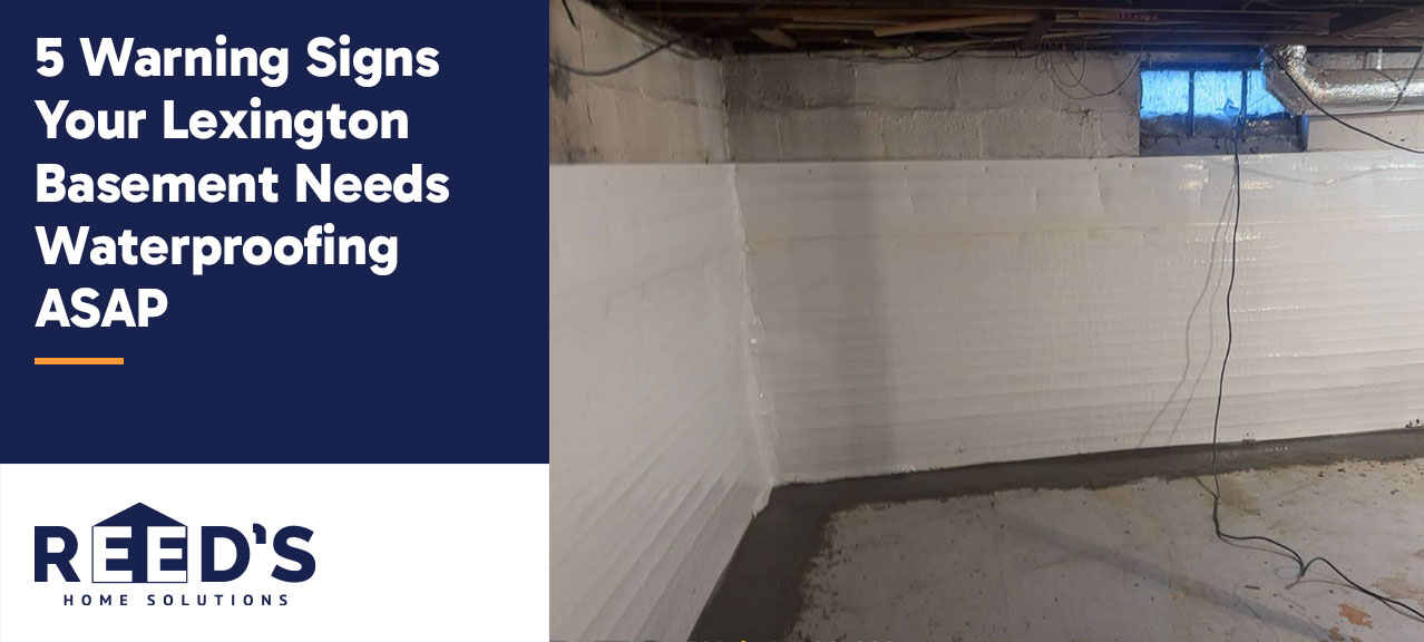 Finished basement waterproofing system in a Lexington, Kentucky basement featuring bright wall panels and a perimeter drainage channel designed to manage water intrusion and keep the basement dry.