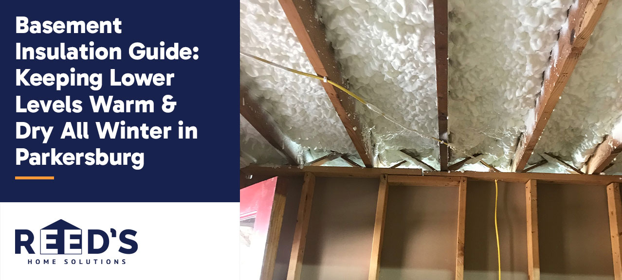 "Basement Insulation Guide: Keeping Lower Levels Warm & Dry All Winter in Parkersburg" beside a basement ceiling insulated with spray foam between exposed floor joists.